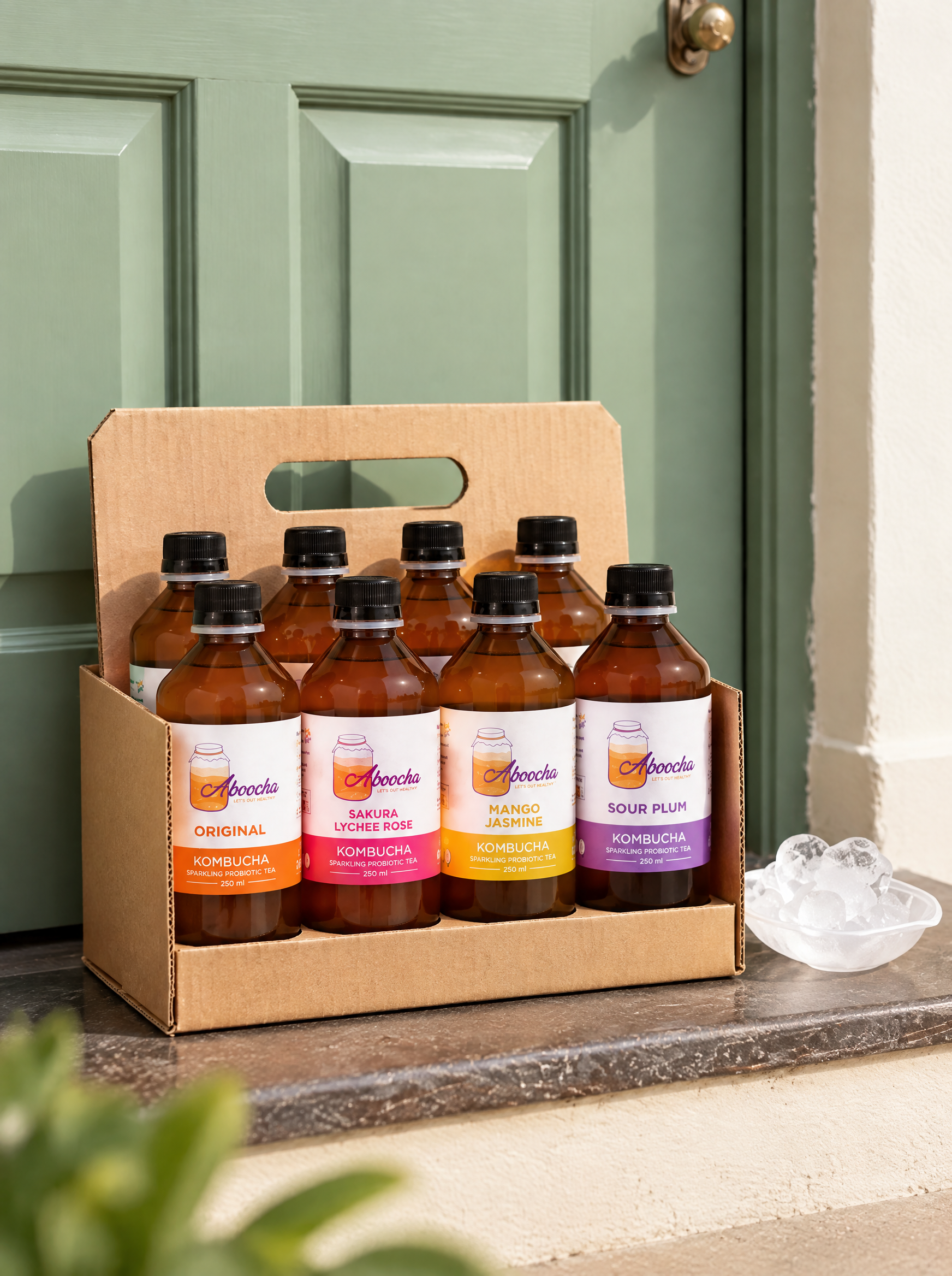 Chilled Aboocha kombucha bottles with ice and condensation